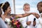 African American couple getting married at the beach