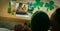 African american couple having st patrick\\\'s day video call with male friends on laptop at home