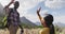 African american couple high fiving each other while trekking in the mountains