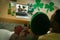 African american couple making st patrick\\\'s day video call with smiling couple on laptop at home