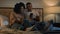 African American couple man and woman husband wife boyfriend girlfriend using mobile phone together lying in bed at