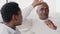 African american couple mature man and afro young girl woman sitting indoors at home talking communication talk dialogue