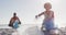 African american couple segregating waste together on dirty sunny beach