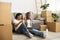 African american couple sitting on the floor looking at laptop