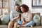 African american couple with smartphone at home