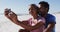 African american couple smiling taking selfie with smartphone on the beach