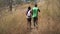 African american couple Trail running take a break Drinking Water in Meadow on mountain outdoors. sport adventure . black fit