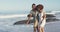 African American couple walking seaside and kissing