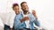 African-american dad and daughter blowing soap bubbles together