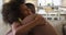 African american daughter and her father smiling and hugging on couch