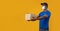 African american delivery guy in medical mask giving cardboard box