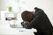 African-american distraught businessman sleeping at workplace fe