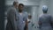African American doctor and elderly patient in hospital hallway