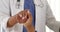 African American doctor holding patient\'s hand