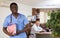 African american doctor with papers in hands standing in medical office