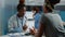 African american doctor and patient looking at human skeleton