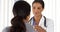 African American doctor talking to female patient