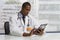 African American doctor using electronic tablet, horizontal