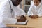 African American doctor write prescription to child patient