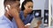 African American doctors using tablet and phone to work together