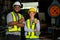 African American factory workers man and woman show thumbs up and look at camera with smiling during work in industry workplace