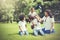 African American family alongside with Asian mum being playful and having good times in the park