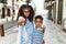 African american family of bother and sister standing at the street pointing with finger to the camera and to you, confident