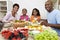 African American Family Eating At Dining Table