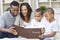 African American Family Looking At Photo Album