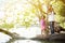 African American family pointing up the sky and standing on tree around the lake.