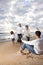 African-American family running to dad on beach