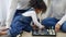 African American family teaching their son to play chess