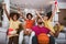 African American family of three watching tv and cheering basketball games on sofa at home