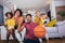 African American family watching tv and cheering basketball games on sofa at home