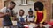 African american family wearing aprons baking together in the kitchen at home