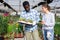 African american farmer with cactus looks at information about them with