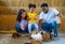 African American father and Asian mother enjoin with their daughter to have fun and relax activity to feed and play with rabbit in