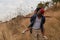 African american father and daughter having fun playing piggyback together during traveling countryside