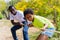 African American father and daughter pulling a rope together in tug of war competition - family on leisure activity on