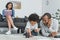 african american father drawing with son and mother reading book