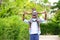 African American father gave piggyback ride to his little daughter and having a good time together walking around the neighborhood