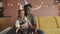 African American father holds son - blowing three candles on birthday's cake