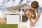 African American Father and Mixed Race Son In Front of Blank Real Estate Sign and House