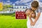 African American Father and Son In Front of Sale Sign and House