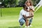 african american father squatting and hugging adorable daughter with teddy bear