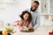 African american father teaching daughter how to prepare salad