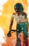 African american female athlete wearing helmet and eyewear riding bike over yellow smoky background