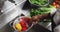 African american female chef washing vegetables in colander in restaurant kitchen