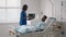 An African-American female doctor comes to the patient and asks about his condition and conducts an examination