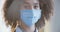 African american female doctor wear white medical coat and face mask look at camera, closeup headshot portrait. Brave